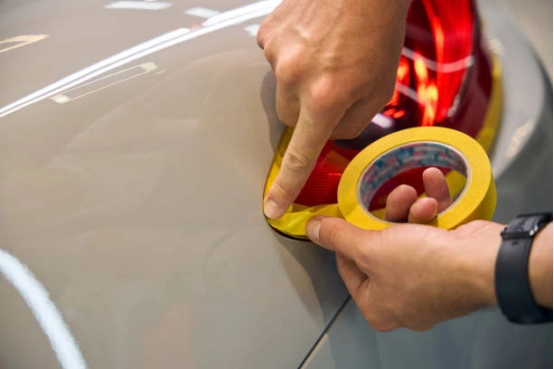 car prepared for polishing with masking tape